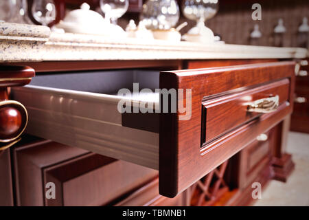 wooden cupboard with opened empty drawer Stock Photo