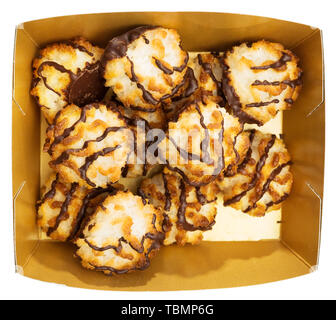 Coconut macaroons in chocolate glaze in carton box. Delicate baked dessert. Isolated over white background Stock Photo