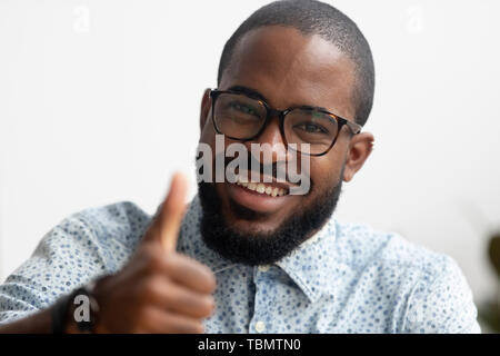 Portrait of smart smiling African American businessman gesturing thumbs up Stock Photo