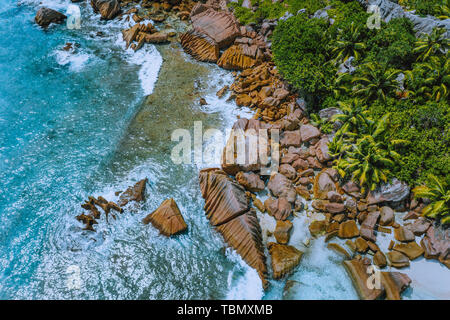 Aerial drone photo of stony part of beautiful anse cocos beach at La Digue, Seychelles Stock Photo