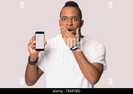 Happy black man using tablet shopping online in studio Stock Photo