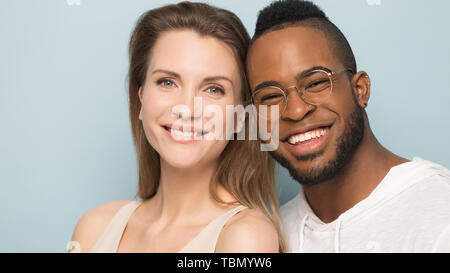 Happy multicultural couple posing for portrait in studio Stock Photo
