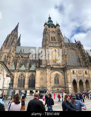 Prague, Czech Republic - May 18, 2019 :  Tourists taking selfies in front of St. Vitus Cathedral in Prague Castle Complex in Czech Republic. Stock Photo