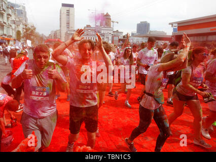 Participants being showered with colours during the event. The Color Run, also known as 'the happiest 5,000 meters on the planet', is an event series and paint race, its first event was in the United States in January 2012 since then the run has spread across the globe leaving a trail of color and happy runners across different continents and countries. The untimed event has no winners or prizes, but runners are showered with colored powder, made of food-grade corn starch, at stations along the run. In Ukrainian capital the first time Kyiv Color Run started in 2014. Stock Photo