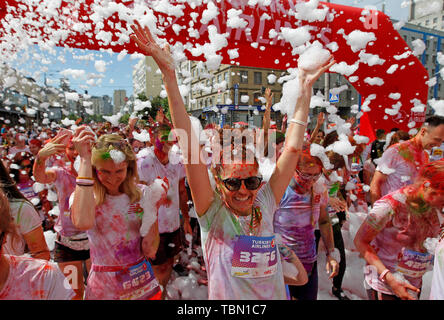 Participants being showered with colours during the event. The Color Run, also known as 'the happiest 5,000 meters on the planet', is an event series and paint race, its first event was in the United States in January 2012 since then the run has spread across the globe leaving a trail of color and happy runners across different continents and countries. The untimed event has no winners or prizes, but runners are showered with colored powder, made of food-grade corn starch, at stations along the run. In Ukrainian capital the first time Kyiv Color Run started in 2014. Stock Photo