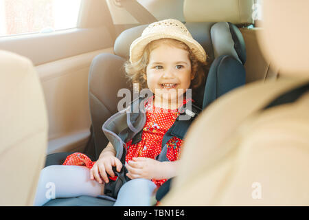 Cute little baby child sitting in car seat. Portrait of cute little baby child sitting in car seat.Safety concept Stock Photo