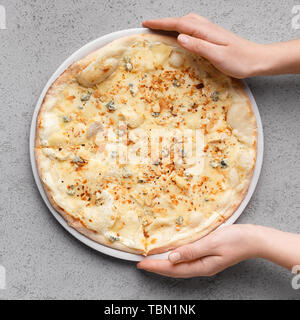 Homemade Pizza. Woman Putting Cheesy Pizza On Table Stock Photo