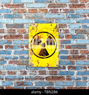 Nuclear site, sign hanging on a brick wall. Indication of the presence of a radioactive area, 3d render. Nuclear weapons. Dangerous site Stock Photo