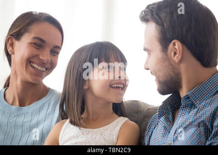 Happy little girl enjoy time spending with young parents Stock Photo