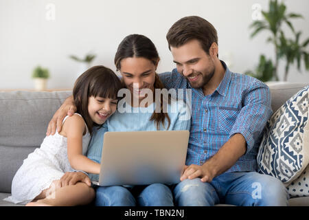 Smiling Parents With Kid Watch Funny Movie On Laptop Stock Photo Alamy