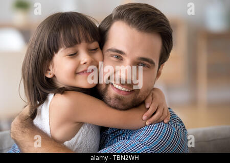 Portrait of cute little daughter hug young father Stock Photo