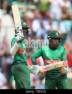 Bangladesh's Shakib Al Hasan (left) reaches his half century during the ICC Cricket World Cup group stage match at The Oval, London. Stock Photo