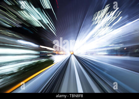 blur motion train in tunnel in tokyo at night Stock Photo