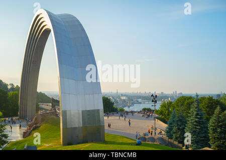 The People's Friendship Arch is a monument in Kiev, Ukraine. Skyline of Podol in the background Stock Photo