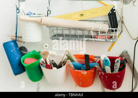 pottery tools for carving ceramic products in workshop Stock Photo
