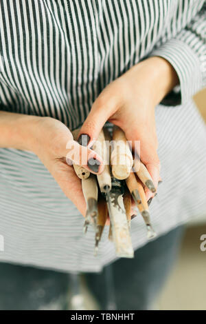 pottery tools for carving ceramic products in workshop Stock Photo