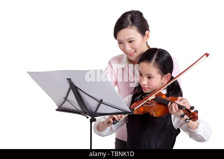 Mother urges daughter to practice violin Stock Photo