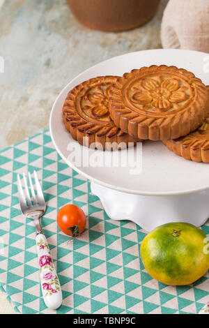 Moon cakes and fruit on the table Stock Photo