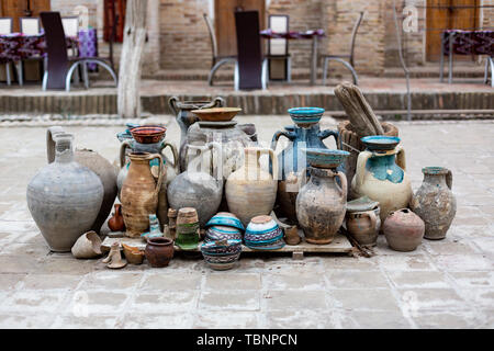 Natural traditional clay pottery beautiful old kitchen appliances, dishes, jugs, vases, pots, mugs. The background. Stock Photo