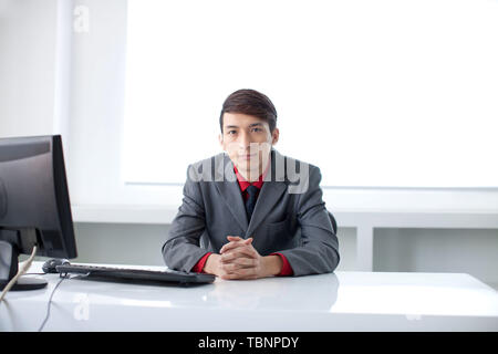 A white-collar worker is busy at work in the office. Stock Photo