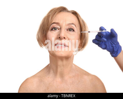 Beautiful mature woman receiving injection against white background Stock Photo