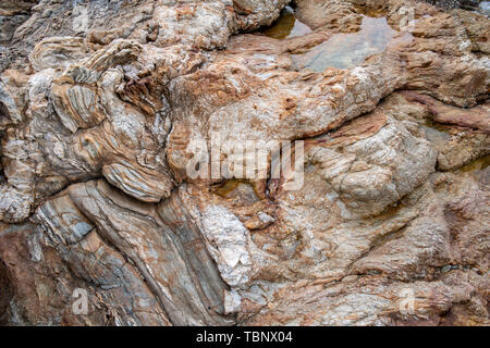 Texture of strange boulder rocks dark nook and warm color with sun lighting. Stock Photo