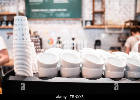 Stack of small ceramic cups on shelf. Stock Photo