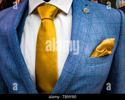 Latest trends in Suit, shirt and tie combination - Blue suit - Yellow tie - White shirt Stock Photo