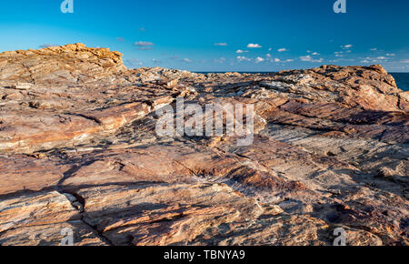 Texture of strange boulder rocks dark nook and warm color with sun lighting. Stock Photo