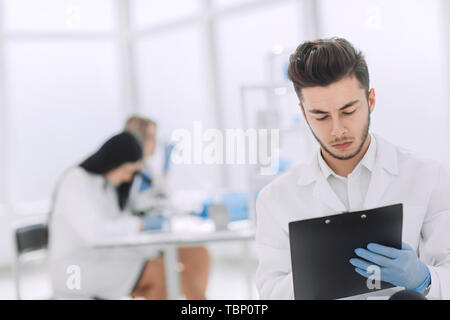 close up. a scientist doing writes the results of an experiment to a laboratory journal . photo with copy space Stock Photo