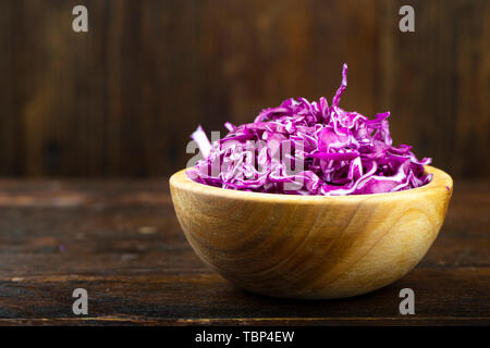 Red cabbage in a wooden plate finely chopped. Healthy food Stock Photo