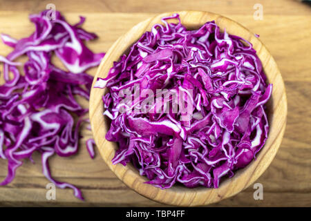 Red cabbage in a wooden plate finely chopped. Healthy food Stock Photo