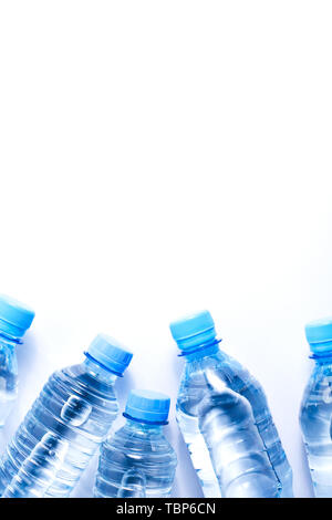 Several drinking water bottles on white background. Eco concept. Copy space for your text. Stock Photo