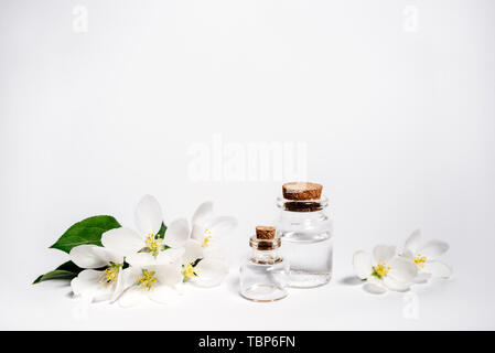 Bottle of apple essential oil and fresh apples on a wooden table. Essential  oil is used to fill lamps, perfumes and in cosmetics. Close-up Stock Photo  - Alamy