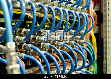 Background image of modern network cables connected in switches in database server room, copy space Stock Photo