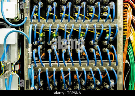 Background image of modern server rack cabinet full of blue cables and wires providing internet in company Stock Photo