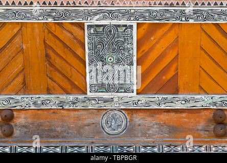 Batak traditional house facade decoration ornaments paintings wood carving, Samosir Island, lake Toba, famous travel destination in Sumatra, Indonesia Stock Photo