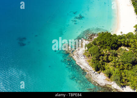 View from above, stunning aerial view of a tropical coast with a white beach bathed by a turquoise clear sea. Phuket, Thailand. Stock Photo