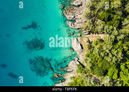 View from above, stunning aerial view of a tropical coast bathed by a turquoise clear sea. Phuket, Thailand. Stock Photo
