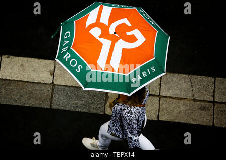 Paris, France. 03rd June, 2019. 03 June 2019, France (France), Paris: FREE OFFER! Tennis: Grand Slam, French Open: A woman walks with an umbrella over the tennis courts in Rolland Garros in rainy weather. Photo: Frank Molter/dpa Credit: dpa picture alliance/Alamy Live News Stock Photo