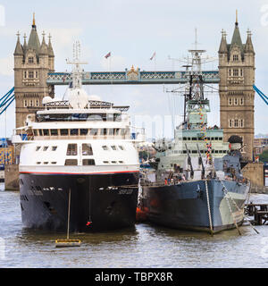 London, UK. 03rd June, 2019. Silver Cloud, a luxury cruise ship operated by Silversea, is snugly moored next to the HMS Belfast on the River Thames in London, with the Tower Bridge in the background. Silver Cloud will begin a 28 day journey to Tromso from London tomorrow. Credit: Imageplotter/Alamy Live News Stock Photo