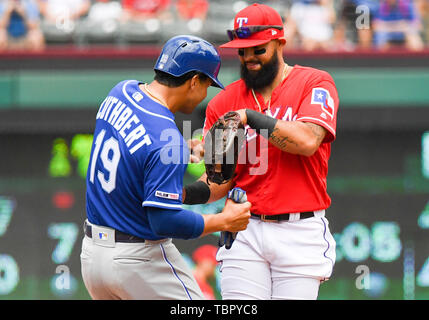 June 02, 2019: Kansas City Royals baserunner Cheslor Cuthbert jokingly  throws punches with Texas Rangers second baseman Rougned Odor #12 during an  afternoon MLB game between the Kansas City Royals and the