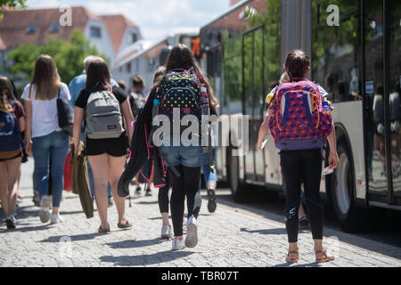 Rottenburg Am Neckar, Germany. 03rd June, 2019. Schoolgirls go to a bus stop in the city centre to standing buses. Credit: Marijan Murat/dpa/Alamy Live News Stock Photo