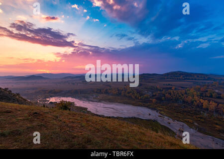 Landscape with mountains, dawn and sky. No one touches nature. Nature. Dusk at night. Outdoor fog. Hills in the autumn. The sun is beautiful, scenic light, valleys, rocks and comfortable weather. Sunrise on the dam. Prairie photography photography color Stock Photo