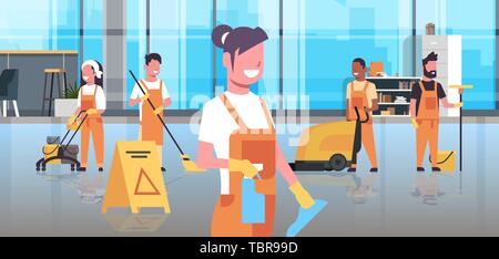 janitors team cleaning service concept cleaners team in uniform working together with professional equipment modern co-working center office interior Stock Vector