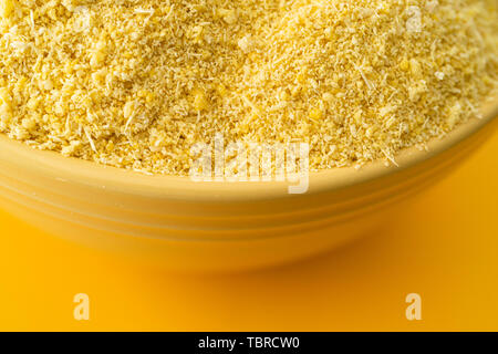 Bowl of Nigerian Yellow Garri in a Yellow bowl Stock Photo