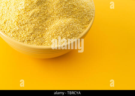 Bowl of Nigerian Yellow Garri in a Yellow bowl Stock Photo