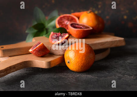 Cutting boards with fresh blood oranges on table Stock Photo