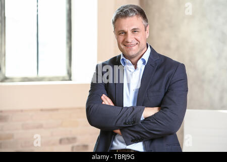 Portrait of handsome mature businessman in office Stock Photo