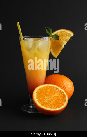 Tequila sunrise cocktail on dark stone table. With space for your text ...